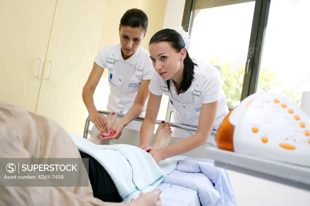 An immobilized patient receives a leg massage provided by specially trained nurse-sophrologists at the Well being space, Limoges hospital, France. This facility aims to improve the patients' hospital stay providing aesthetic and relaxing care.