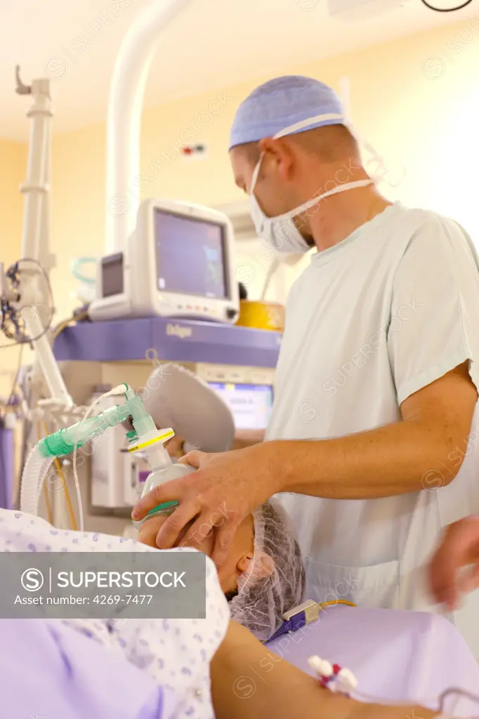 Anesthesiologist attenting patient during surgery. Department of gastroenterological surgery, Limoges hospital, France.