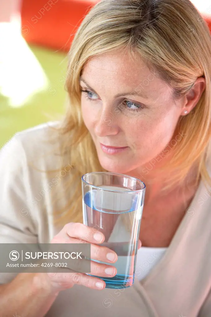 Woman drinking a glass of water.