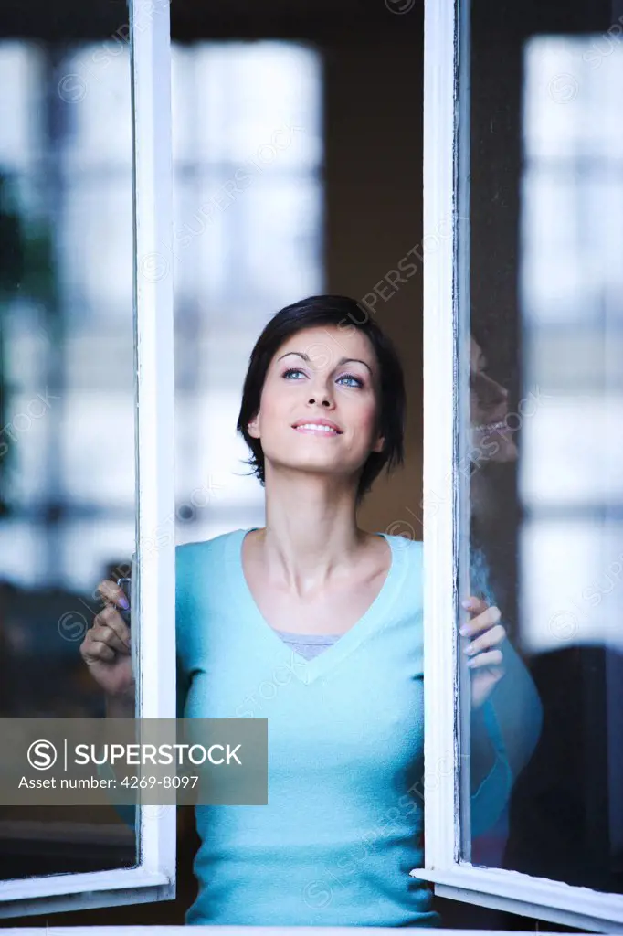 Woman opening window.
