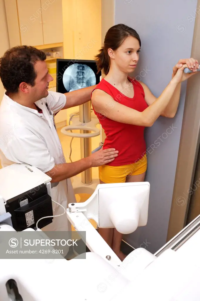 Young woman undergoing backbone X-ray.
