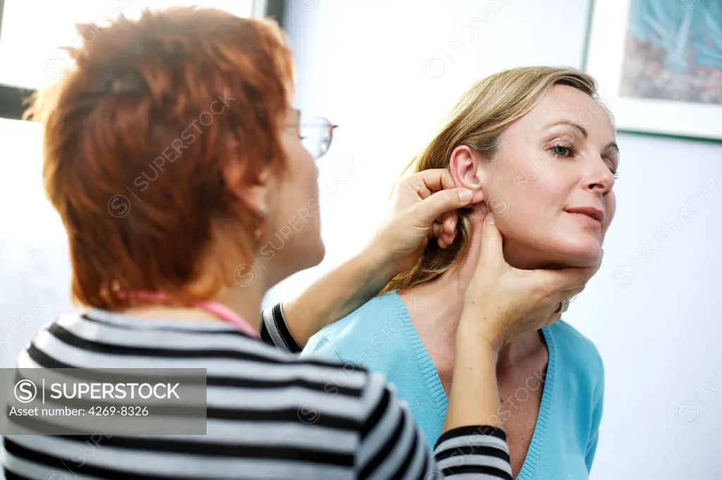 Doctor examining the skin of a patient.