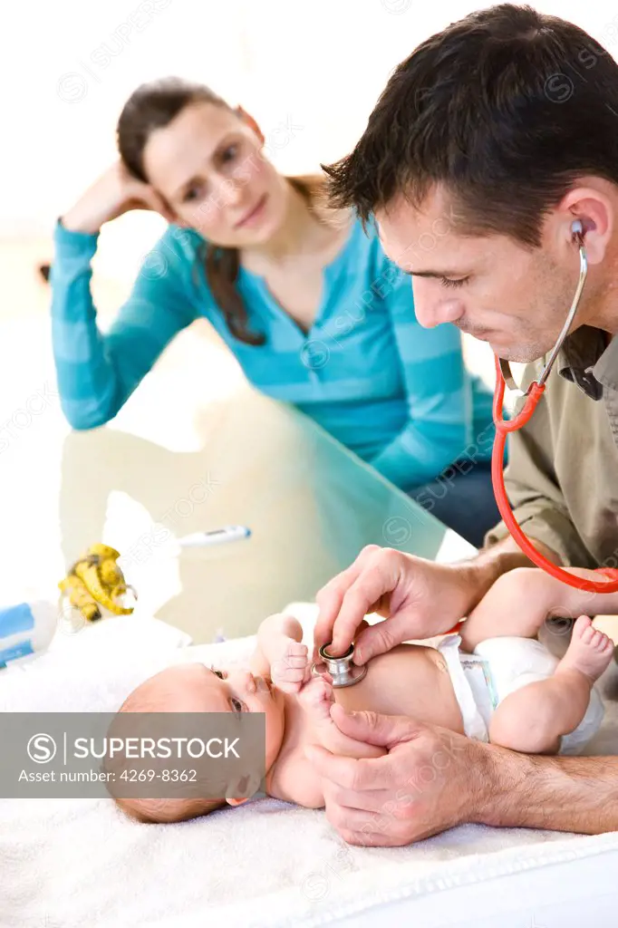 Pediatrician examining 2 months old baby with a stethoscope.