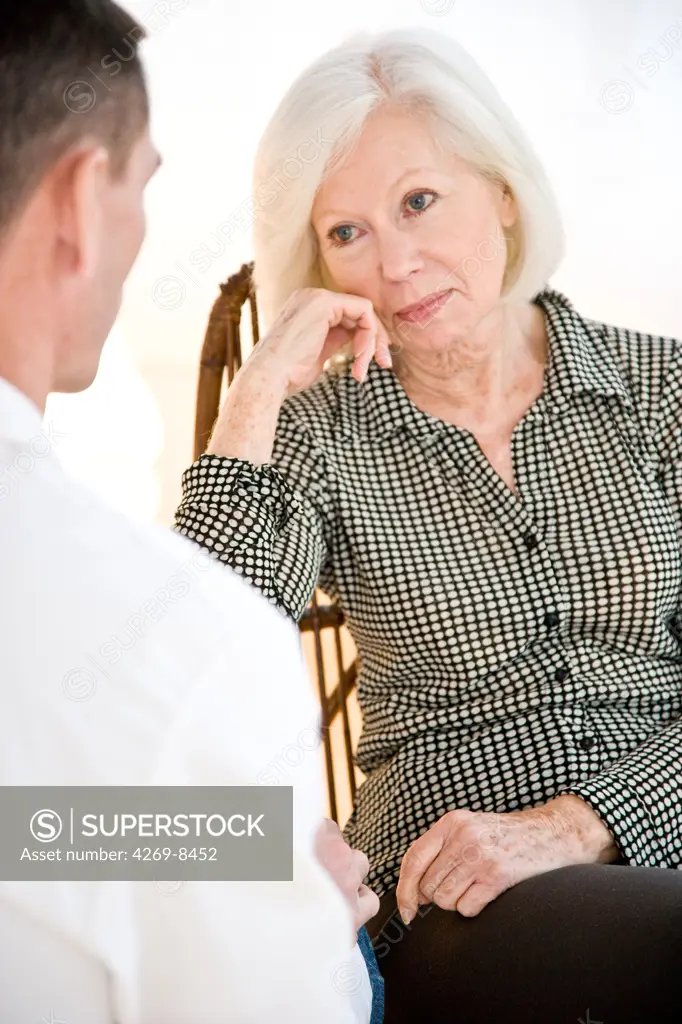 Doctor talking with elderly woman.