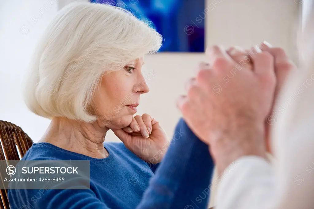 Doctor comforting elderly woman.