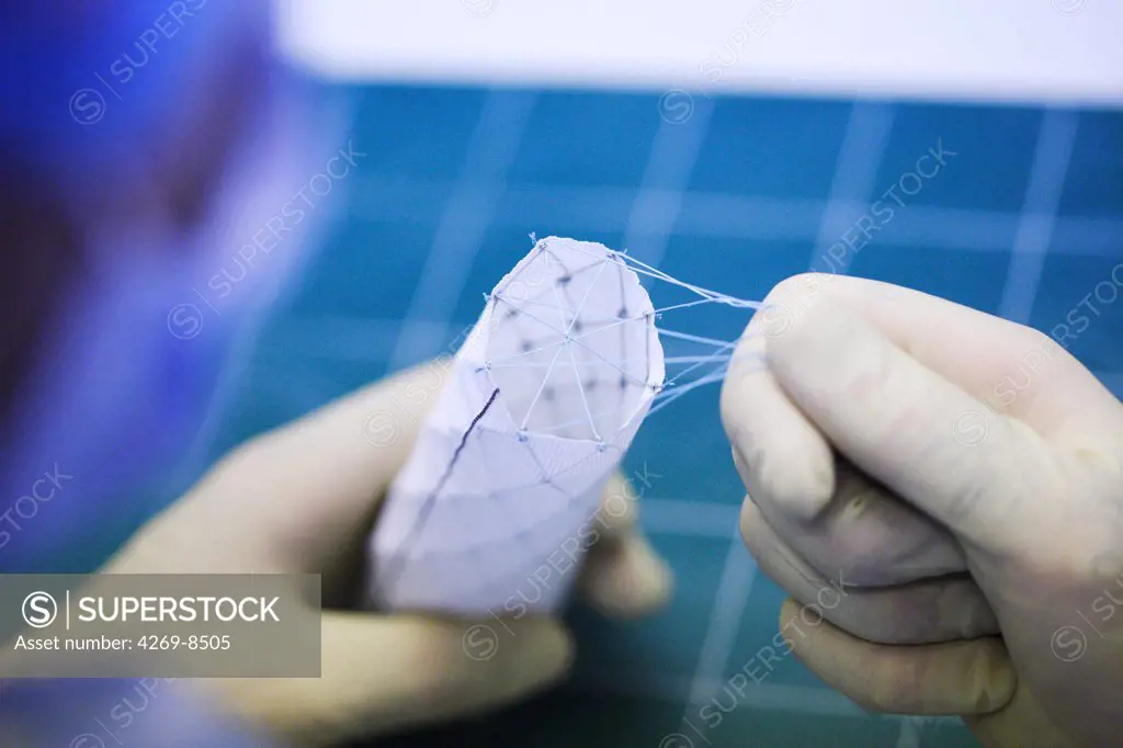This surgery is performed by Pr Fabien Koskas to treat aortic lesions (aneurysm, dissecting aneurysm) with custom-made endovascular implants. Here, surgeon manipulating the endoprothesis. Department of vascular surgery, Pitié-Salpêtrière hospital, Paris, France.