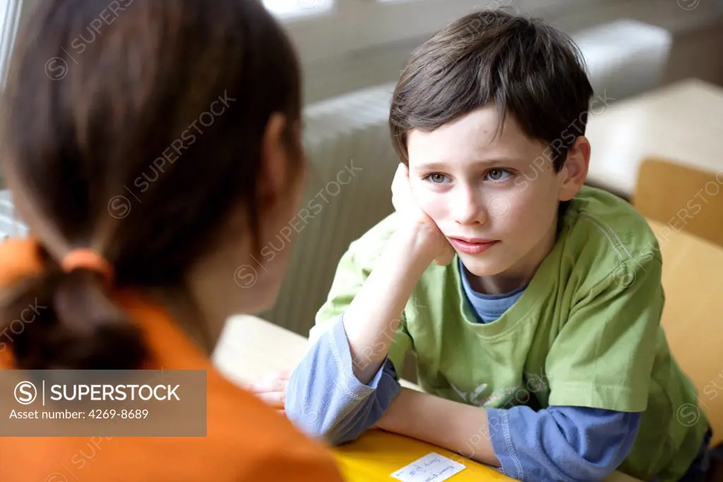 Woman talking with a 8 years old boy.