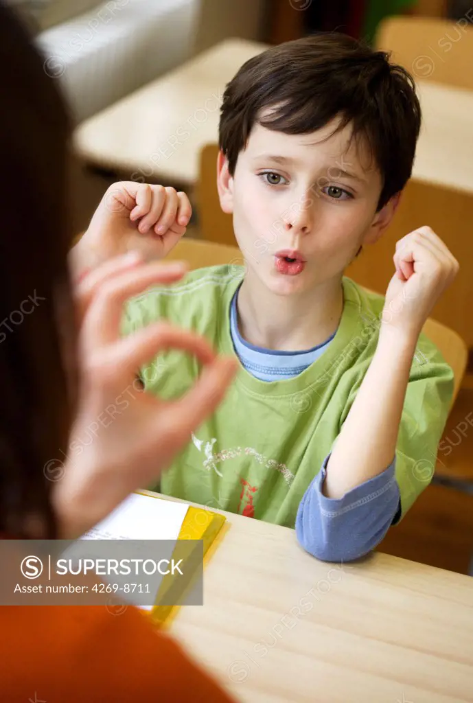 8 years old boy during speech therapy cession.