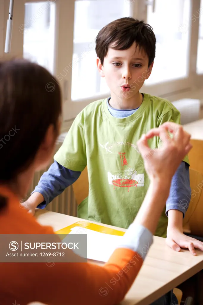 8 years old boy during speech therapy cession.
