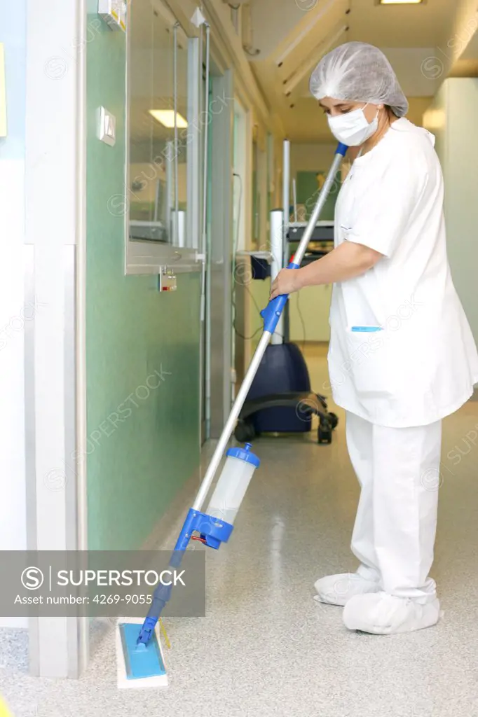 Hospital staff cleaning the floor of sterile unit. Department of Haematology and Immunology, Limoges hospital, France.