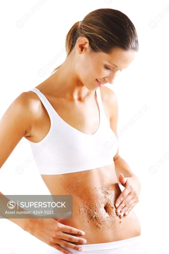 Woman using exfoliating scrub treatment.