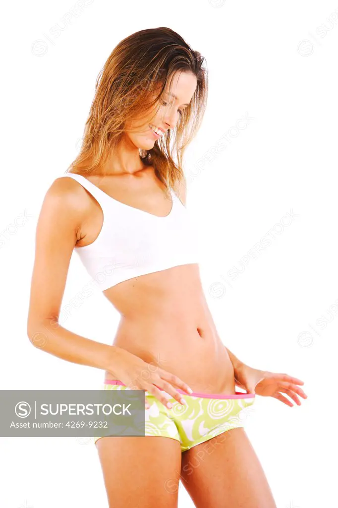 Woman looking at her waist.