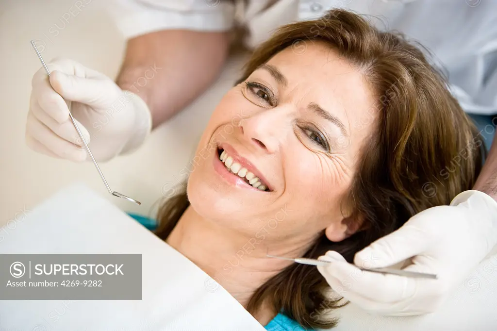 Woman getting dental examination and care at the dentist.