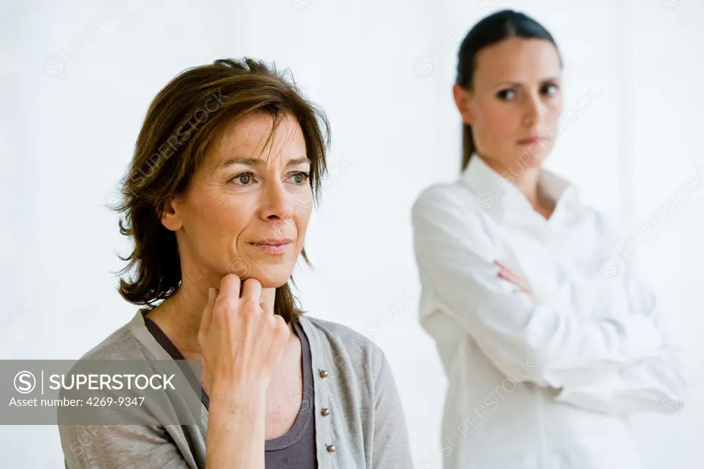 Middle-aged woman and daughter having argument.