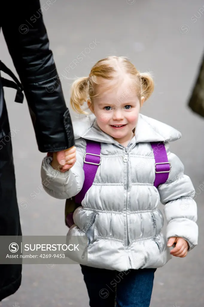 3 years old girl on her way to school.