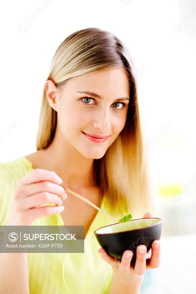 Woman preparing matcha, powdered Japanese green tea.