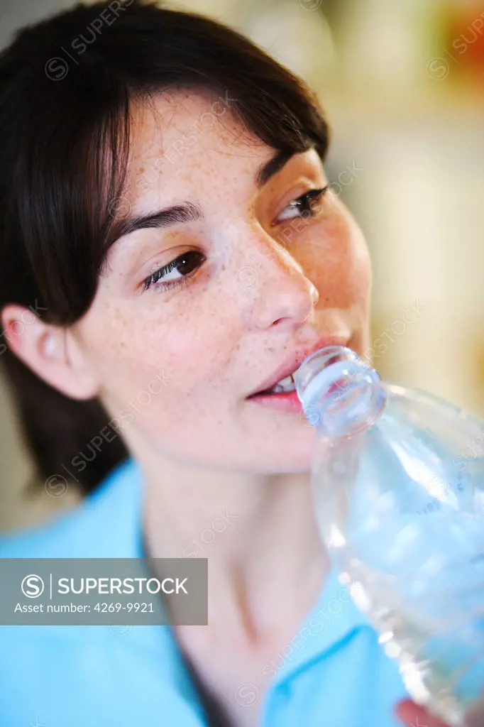 Woman drinking mineral water.