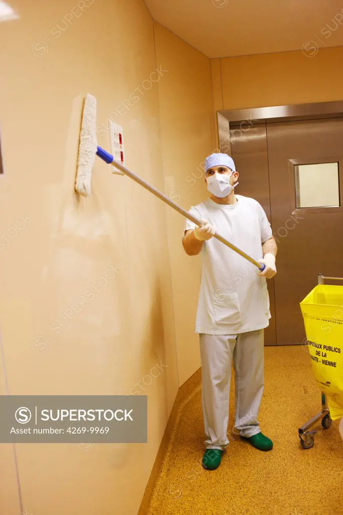 Hospital cleaning staff disinfecting operating room.