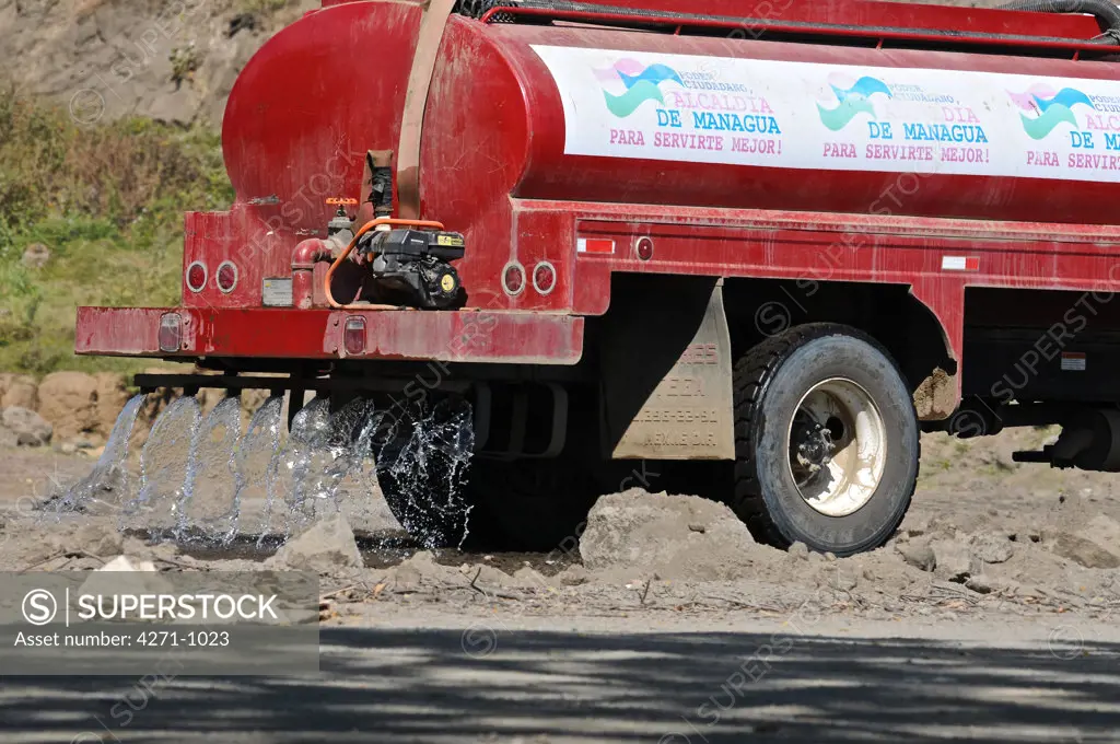 Nicaragua, Managua, Water pouring from truck at La Chureca Industrial waste disposal site