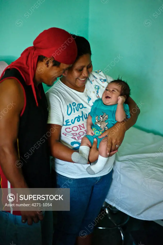 Nicaragua, Managua, Parents with baby boy at hospital near La Chureca Industrial waste disposal site