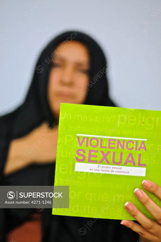 Muslim woman in traditional Islamic clothing, holding booklet