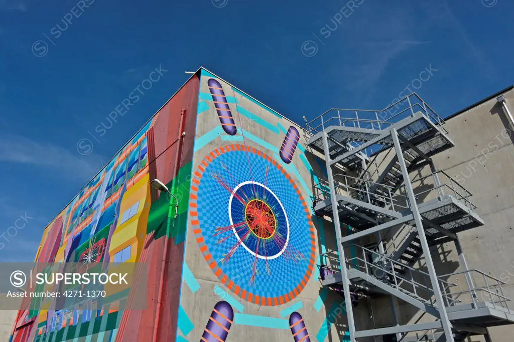 Switzerland, Geneva, Mural on building. ATLAS building, home of the Large Hadron Collider (LHC) and the particle detector control room. CERN, the European Organization for Nuclear Research, is the biggest particle physics laboratory in the world.