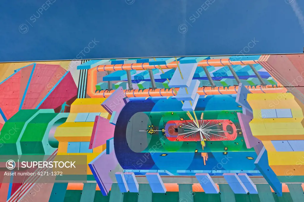 Switzerland, Geneva, Mural on building. ATLAS building, home of the Large Hadron Collider (LHC) and the particle detector control room. CERN, the European Organization for Nuclear Research, is the biggest particle physics laboratory in the world.