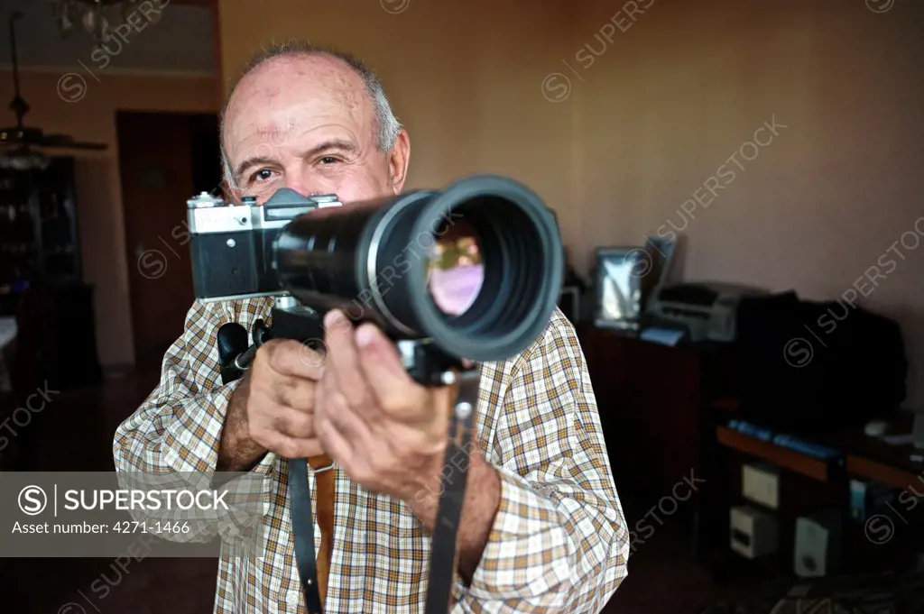 Cuba, Havana, Photographer holding camera and preparing for shot
