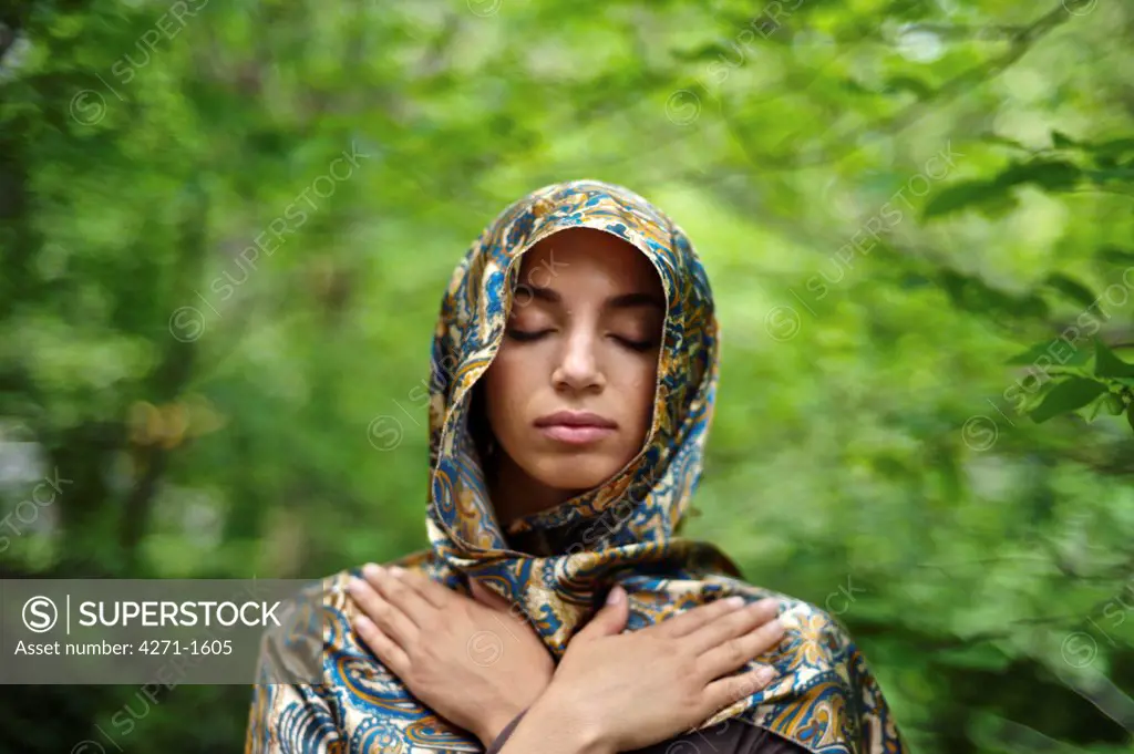USA, New York State, New York City, Central Park, Portrait of young woman wearing headscarf