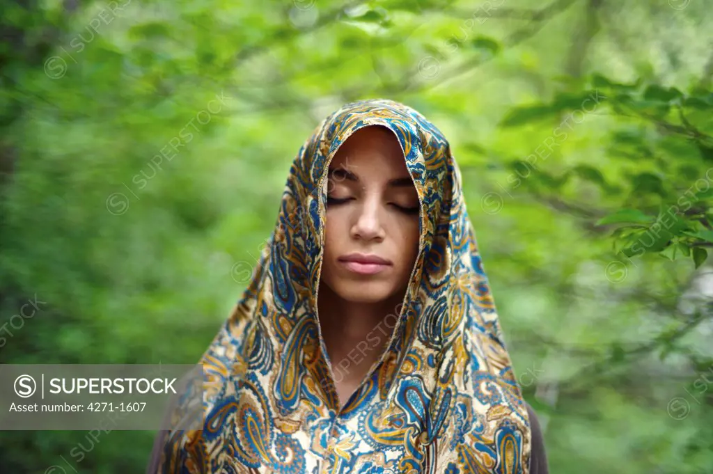 USA, New York State, New York City, Central Park, Portrait of young woman wearing headscarf
