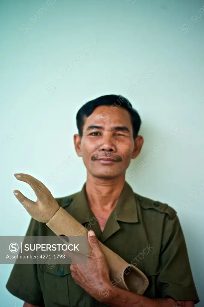 Portrait of a Cambodian land mine survivor lost one eye and an arm, Luang Phabang, Laos