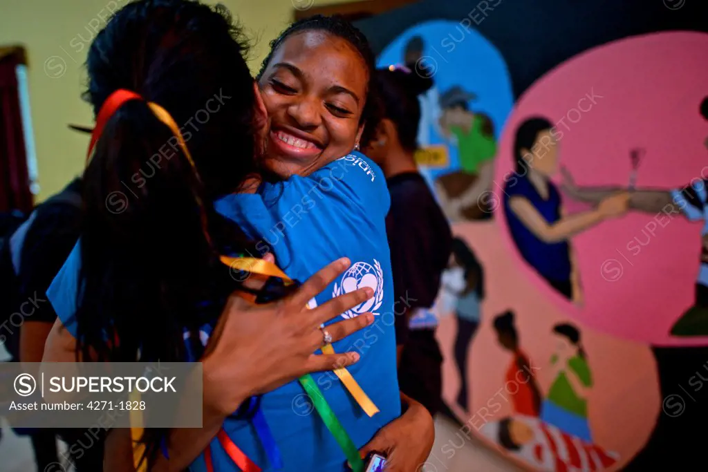 UNICEF Ambassador Angie Harmon hugs a youth leader who works with her peers on issues affecting adolescents in Bluefields, Nicaragua. January 21, 2014. (Kike Calvo / U.S. FUND FOR UNICEF via AP Images)