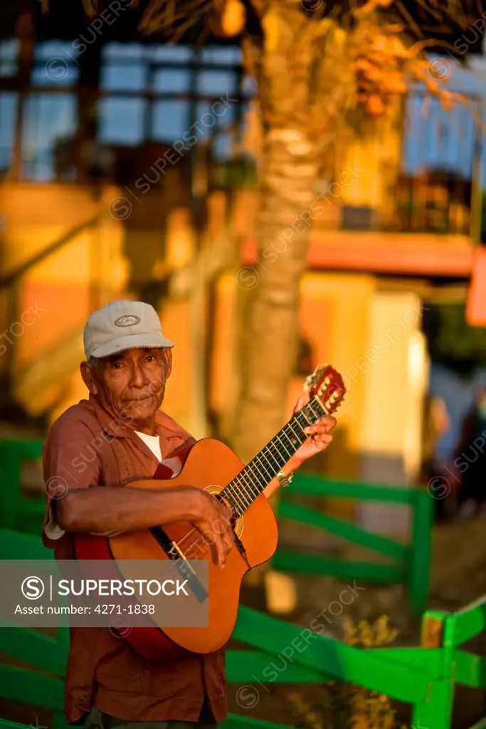 Elderly man playing a Spanish classic guitar