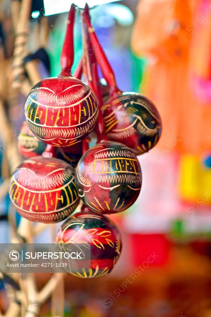 Maracas at an outdoor market. A percussion instrument, usually one of a pair, consisting of a gourd or plastic shell filled with dried seeds, pebble.