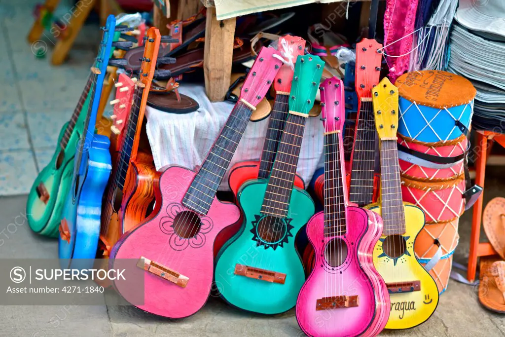 Traditional wood guitars and drums at an outdoor market