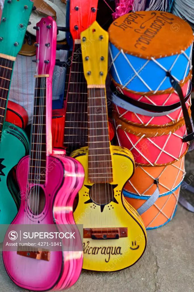 Traditional wood guitars and drums at an outdoor market