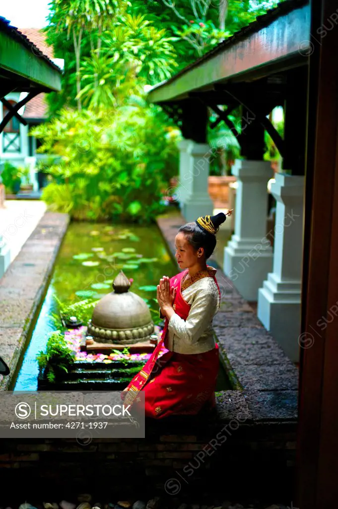 Bride and groom wearing a Lao traditional wedding Gown  Bride meditating,  wearing a Lao traditional wedding Gown. Female: Mani Lao