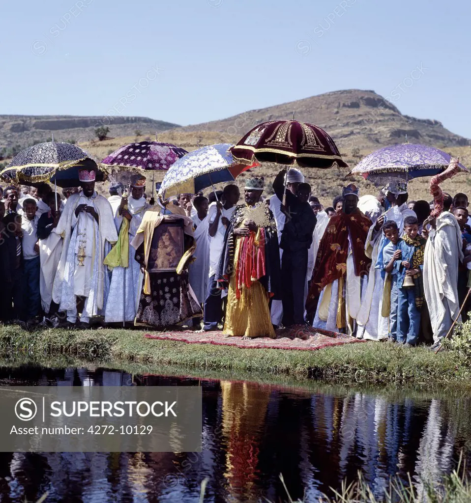 Ethiopian Orthodox priests celebrate Timkat , the churchs most important Holy Day.  Ethiopia is Africa's oldest Christian nation where more than half the population follows the Ethiopian Orthodox faith.  During this ancient celebration, they lead their flock in a long procession to a river or lake symbolising the River Jordan, where baptism of young children takes place.