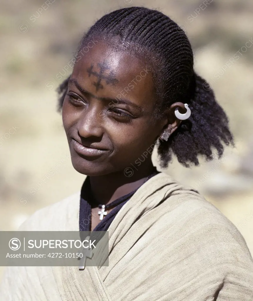 A Tigray woman has a cross of the Ethiopian Orthodox Church tattooed on her forehead while two silver crosses hang round her neck. The people living in the highlands of Northern Ethiopia are deeply religious. They believe in the single divine nature of Christ. Ethiopia is Africas oldest Christian nation.