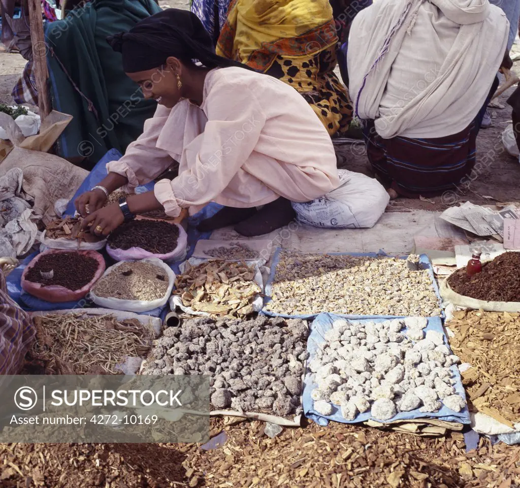 A woman sells various fragrant woods and frankincense at Bati market. Situated on top of the western scarp of the Abyssinian Rift, Bati is the largest open air market in Ethiopia. Nomads and their camels trek long distances every week from the harsh low lying deserts to barter with Amhara and Oromo farmers living in the fertile highlands.