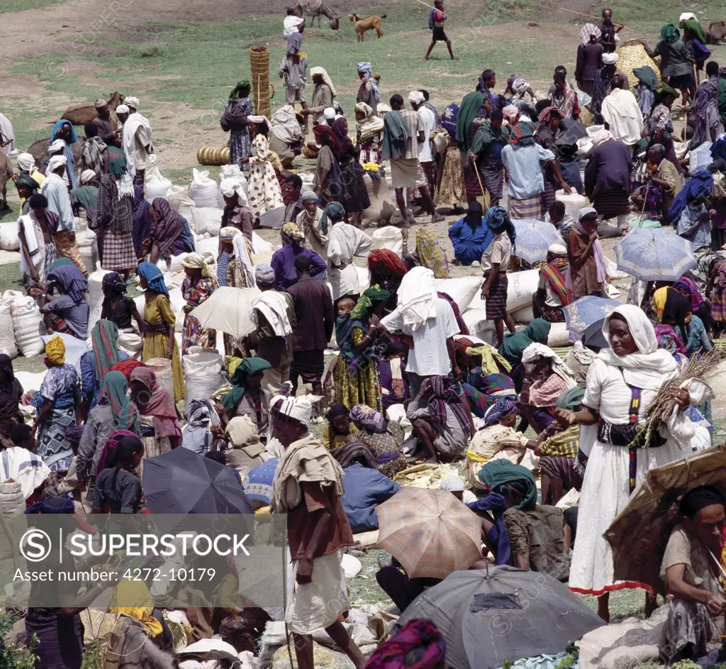 A large gathering of people at Senbetes livestock market, which is an important weekly market close to the western scarp of the Abyssinian Rift. Afar nomads from the low-lying arid regions of Eastern Ethiopia trek long distances there to barter with Amhara and Oromo farmers living in the fertile highlands.