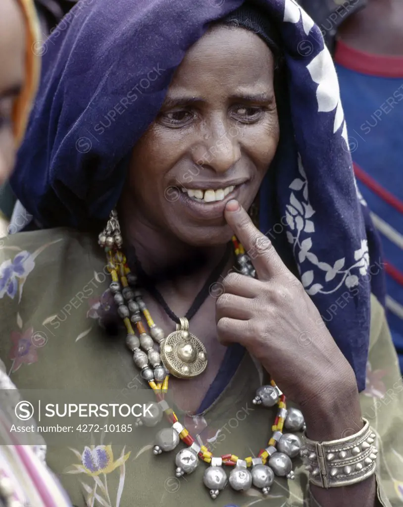 An Oromo woman at Senbete market wears old silver and brass jewellery. Senbete is an important weekly market close to the western scarp of the Abyssinian Rift. Afar nomads from the low lying arid regions of Eastern Ethiopia trek long distances there to barter with Amhara and Oromo farmers living in the fertile highlands.