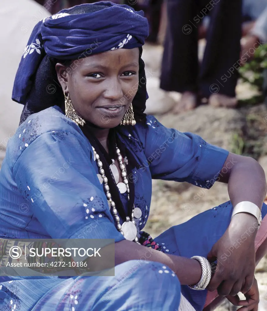 A woman at Senbete market wears old silver and brass jewellery. Her two pendants are made from Maria Theresa thalers  old silver coins minted in Austria, which were widely used as currency in northern Ethiopia and Arabia until the end of World War II.