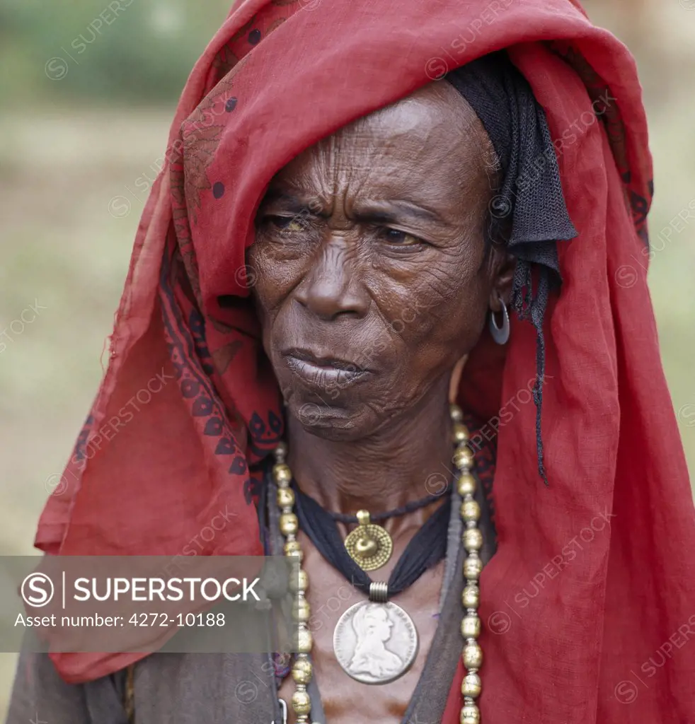 An old Oromo woman wears a brass necklace and pendant, and a silver pendant made from a Maria Theresa thaler an old silver coin minted in Austria, which was widely used as currency in northern Ethiopia and Arabia until the end of World War II.
