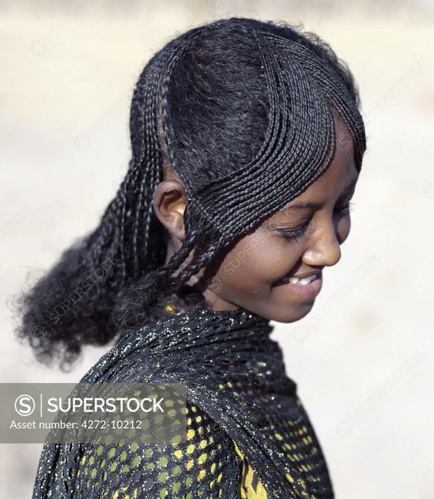 The fetching hairstyle of a young Afar girl. Proud and fiercely independent, the nomadic Afar people live in the low-lying deserts of Eastern Ethiopia.