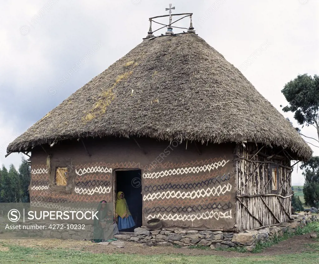 An attractively decorated traditional thatched house belonging to an Orthodox Christian community in the Ethiopian Highlands, northeast of Addis Ababa. Most Amhara people living in the Ethiopian Highlands adhere to the Ethiopian Orthodox faith.  Ethiopia is Africa's oldest Christian nation.