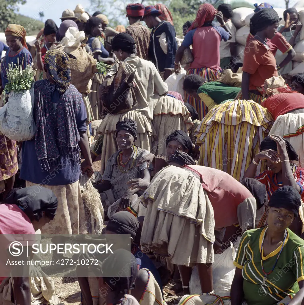 The busy weekly market at Konso trading centre. The women's skirts are made from a thick cotton cloth, called buluko. The cotton is locally grown and weaved by their menfolk.  The Konso people are very industrious farmers, cultivating poor soil on terraces, which are buttressed with stones and rock.