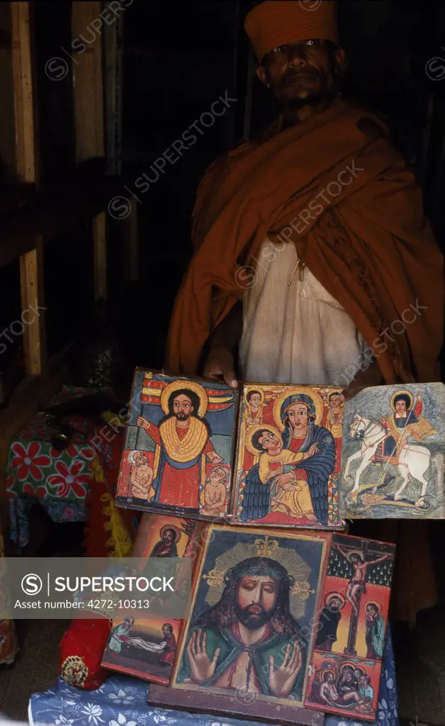 A priest at Kebran Gabriel Church shows several of its many ancient illustrated books; the church has the largest library in the Tana region.