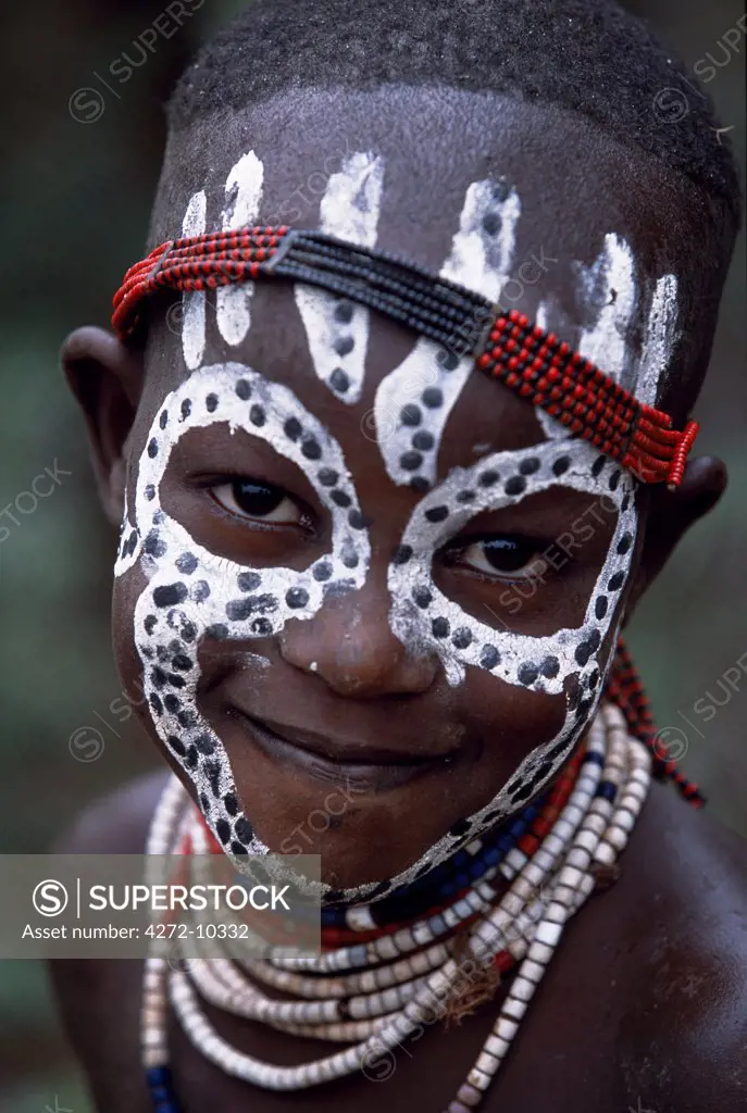 A young Karo girl shows off her attractive make up.  A small Omotic tribe related to the Hamar, who live along the banks of the Omo River in southwestern Ethiopia, the Karo are renowned for their elaborate body painting using white chalk, crushed rock and other natural pigments.