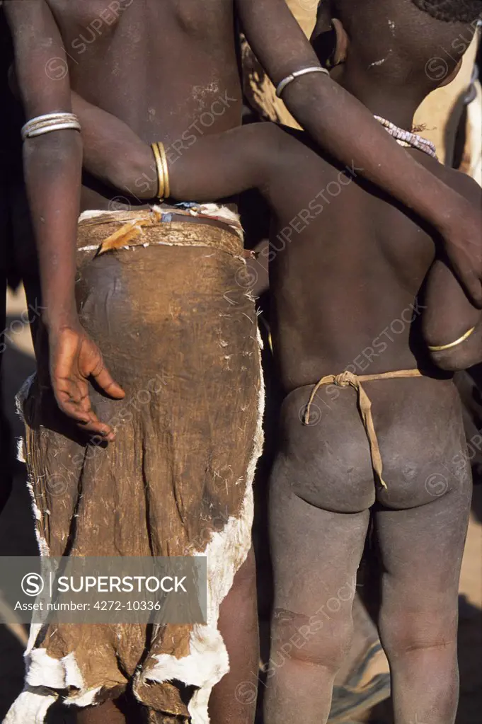 Two Karo children stand together, arm in arm.  A small Omotic tribe related to the Hamar, who live along the banks of the Omo River in southwestern Ethiopia, the Karo are renowned for their elaborate body painting using white chalk, crushed rock and other natural pigments.